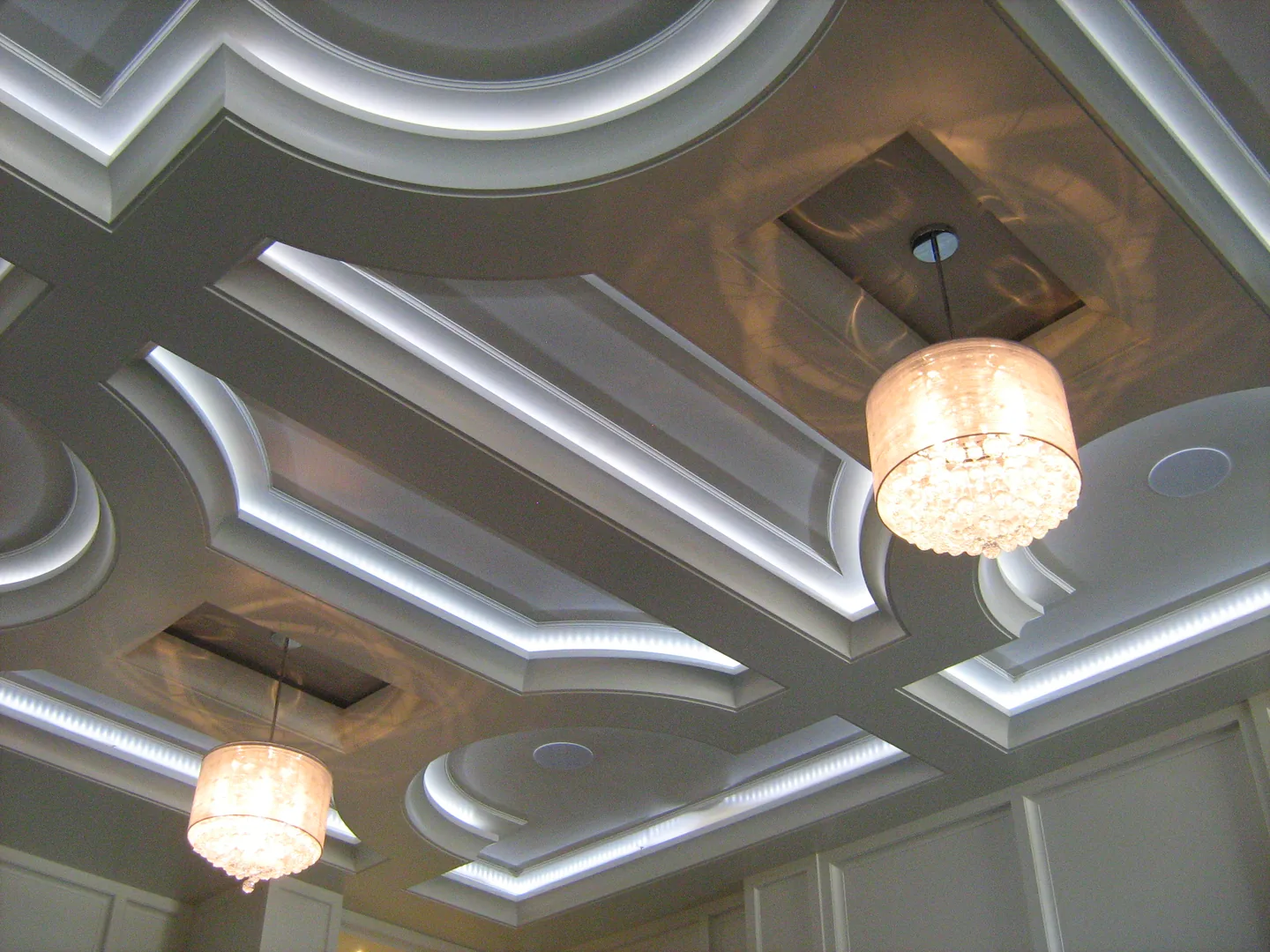 Illuminated ceiling recesses and chandeliers in a residential interior